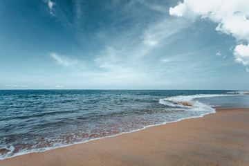 Beautiful sea waves with foam of turquoise color Horizon with blue sky and Beautiful sand