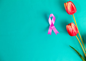 Pink ribbon for breast cancer awareness with tulips flower.