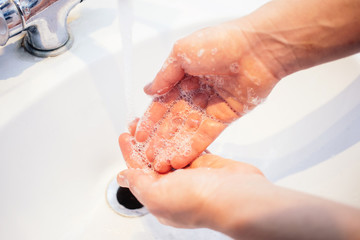 Fototapeta premium wash your hands under water