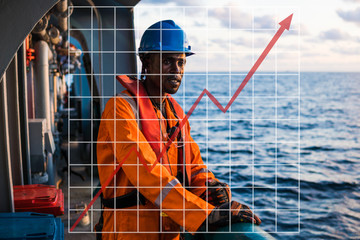 Concept of growth up in marine industry with rising graphics. Seaman AB or Bosun on deck of vessel or ship , wearing PPE.