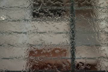 Water splash droplet on a big glass surface.Selective focus