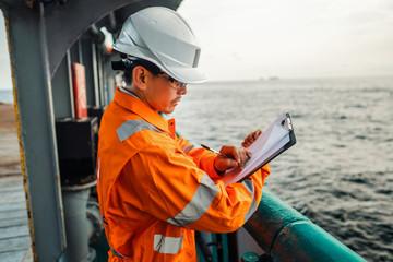 Filipino deck Officer on deck of offshore vessel or ship , wearing PPE personal protective...