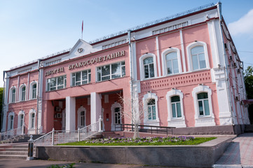 Fototapeta na wymiar Russia, Blagoveshchensk, July 2019: Summer. The building of the wedding Palace in the center of Blagoveshchensk