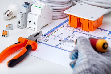 Repair, renovation, electricity, concept. Electrician working with electrical scheme.