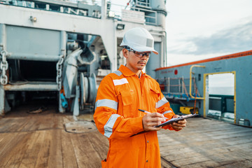 Filipino deck Officer on deck of offshore vessel or ship , wearing PPE personal protective...