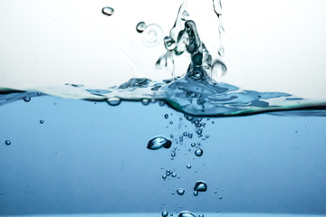 Wave and air bubbles on surface of water