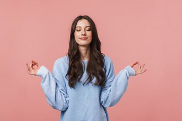 Image of attractive young woman meditating and keeping fingers together - obrazy, fototapety, plakaty