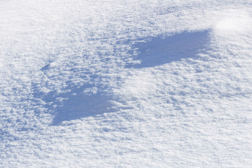 abstract clear white snow in sunny day as a background.