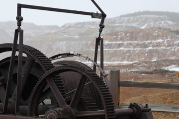 Open pit mining with an antique winch in the foreground