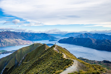 Roys peak mountain hike in Wanaka New Zealand. Popular tourism travel destination. Concept for hiking travel and adventure. New Zealand landscape background.	