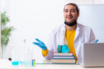 Young male chemist student preparing for exam