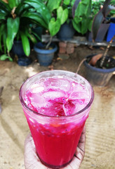 A glass of cool drink in the hand.