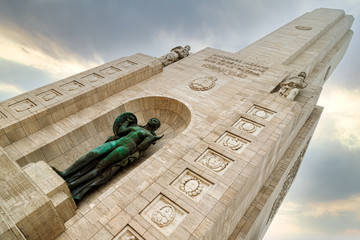 Tower of the National Monument to the Flag of Rosario (Argentina) seen from below with sunset sky