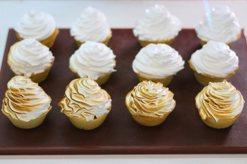 Mini tartlet with lemon and meringue. Tartlet with Italian meringue and lemon cream selective focus