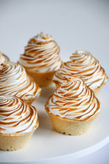 lemon meringue tart closeup on white background. lemon curd tart. tasty lemon mini meringue pie