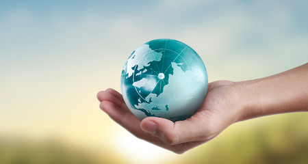 Globe ,earth in hand, holding our planet glowing. Earth image provided by Nasa