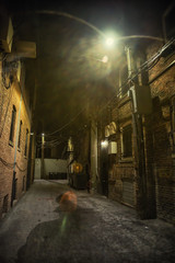 Dark and eerie urban city alley at night 