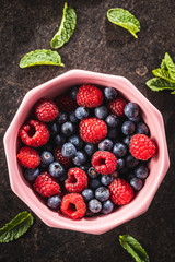Berry fruit. Raspberries and blueberries in bowl.
