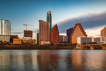 Fototapeta na wymiar Downtown view across Lady Bird Lake or Town Lake on Colorado River at sunset golden hour in Austin, Texas, USA