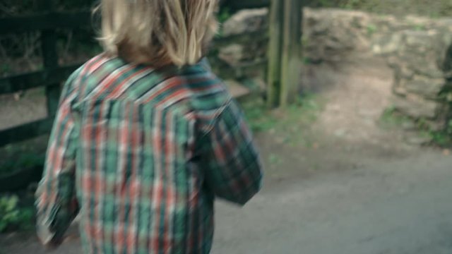 Little boy walking on road in the countryside