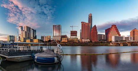 Panorama with downtown view across Lady Bird Lake or Town Lake on Colorado River at sunset golden...