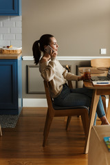 Smiling lovely woman talking on mobile phone