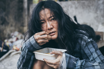 poor people,homeless or beggar begging for help sitting at dirty slum.concept for poverty...