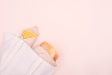 Zero waste concept. Cotton bag with food, with bread and spaghetti. Food delivery. Top view, copy space.