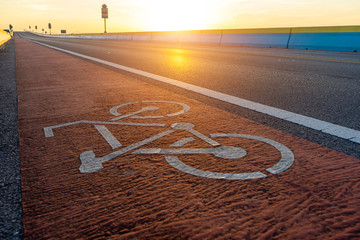 Abstract Bicycle icon on the road with sunlight.