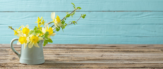 yellow spring flowers on old wooden background