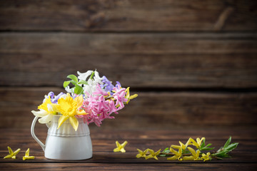 beautiful spring flowers on dark old wooden background