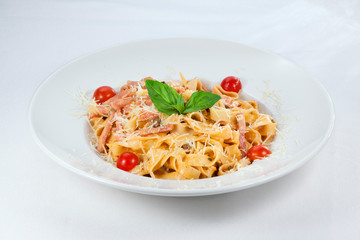 pasta with cheese and tomatoes on a white background