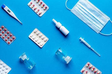 Cold, flu and virus treatment - flat lay with medicine - on blue background top view