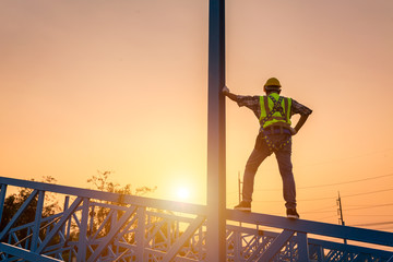 [safety body construction] Engineer working in a metal roof structure, Construction engineer wear...