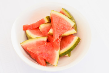 Mediterranean marinated watermelon on isolated white background, special food delivery restaurant menu, take out order, white bowl plate, sliced
