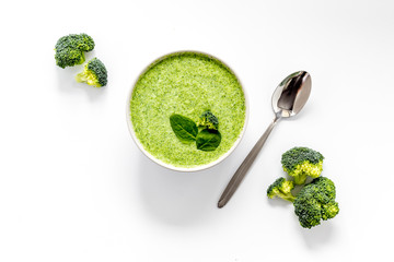 Green vegetable cream soup - broccoli - on white kitchen table top view