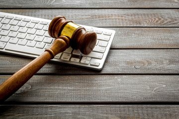 Judge hammer, keyboard on wooden lawyer's desk space for text