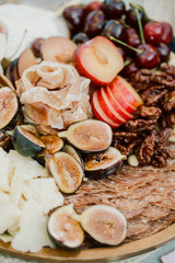 A close up of ripe figs on a charcuterie plate