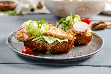 Bruschetta with turkey in nut sauce in gray plate