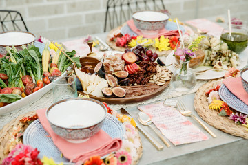 A table set with food and beautiful styling awaiting guests to arrive