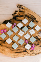 Calligraphed place cards for dinner arrranged on a wooden plank