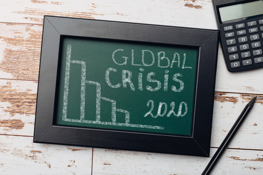 charts of economics and stock markets on a chalk board. financial crisis concept.