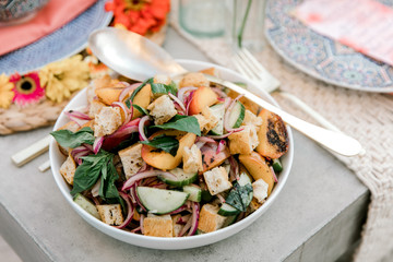 A close up of a summer salad made with ripe vegetables and fruit