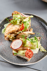 Bruschetta with turkey in nut sauce in gray plate