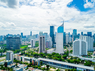 Aerial View of Jakarta Downtown Skyline with High-Rise Buildings With White Clouds and Blue Sky, Indonesia, Asia