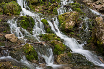 Fototapeta premium City Cesis, Latvia. Old waterfall with green moss and dolomite rocks.