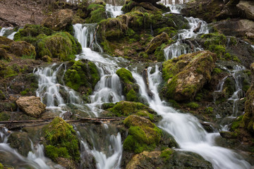 Naklejka na ściany i meble City Cesis, Latvia. Old waterfall with green moss and dolomite rocks.