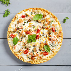 Seafood pizza on wooden board