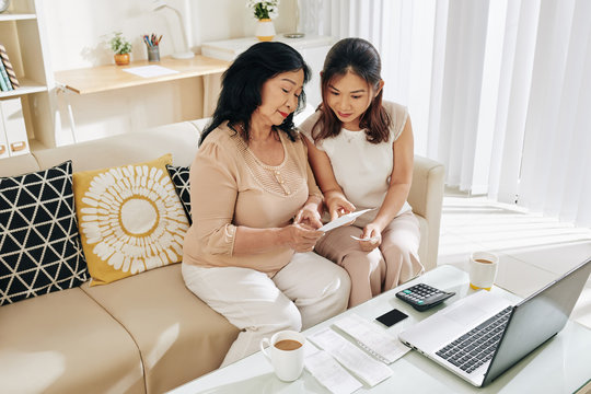 Senior Vietnamese Woman Asking Daughter To Help With Paying Bills Online