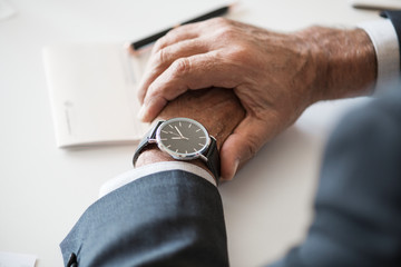 Businessman checking time on hand watch